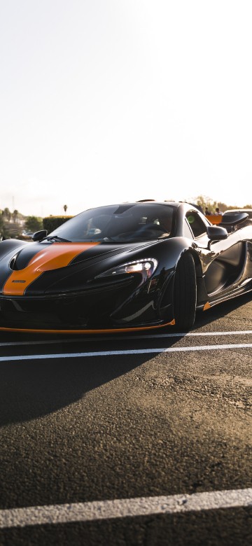 Image black and orange sports car on road during daytime