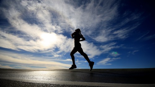 Image silhouette of woman jumping on beach during daytime