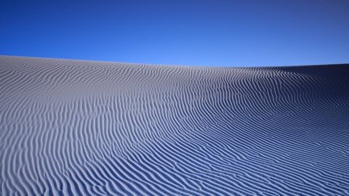 Image white sand under blue sky during daytime