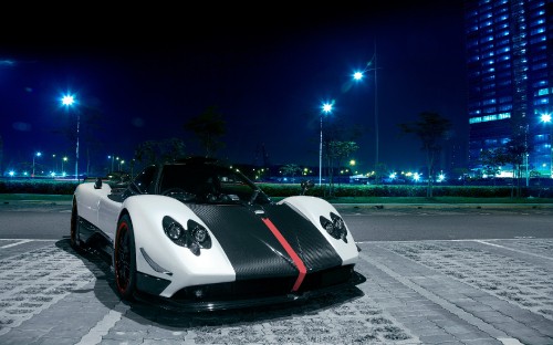 Image white and black sports car on road during night time