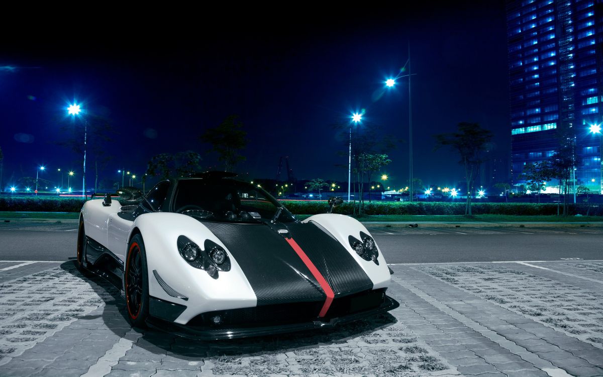 white and black sports car on road during night time