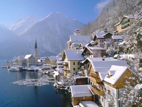 Image white and brown houses near body of water during daytime