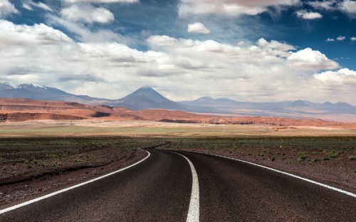 Image gray asphalt road near brown field under white clouds during daytime