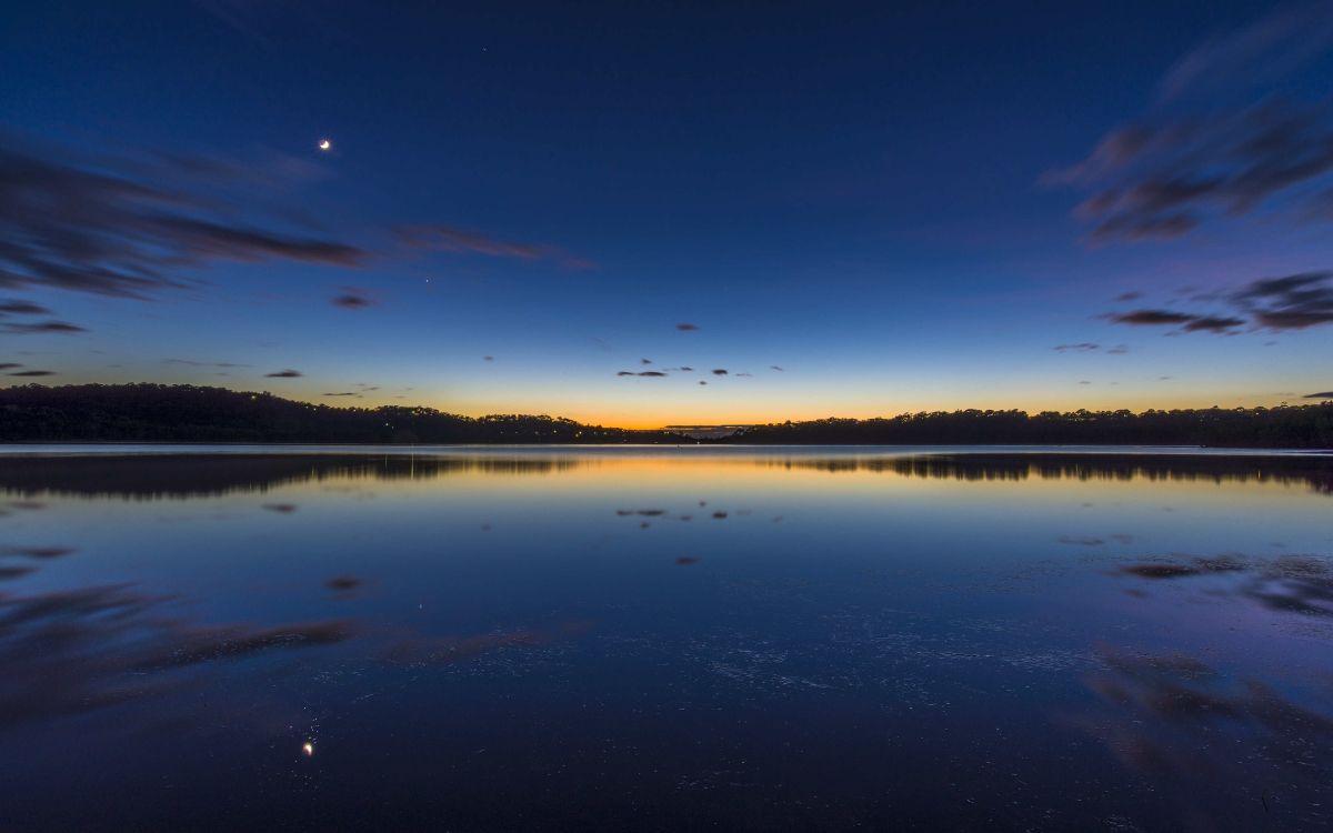 body of water under blue sky during daytime