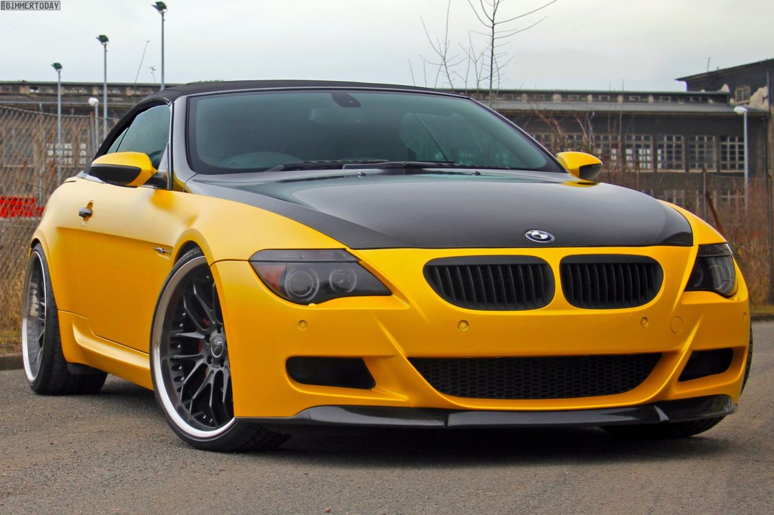 yellow bmw m 3 coupe parked on road during daytime