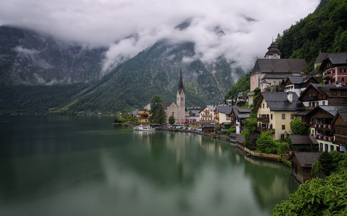 brown and white concrete house beside lake