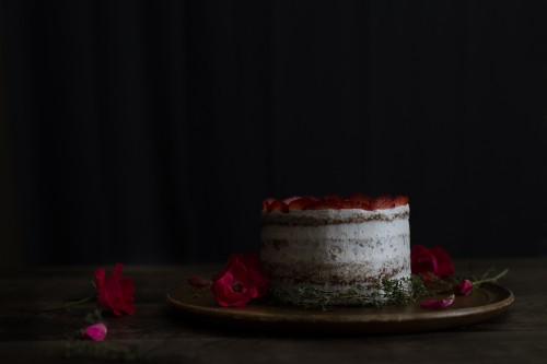 Image white and red cake on brown wooden table