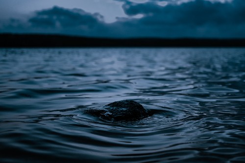 Image body of water under cloudy sky during daytime