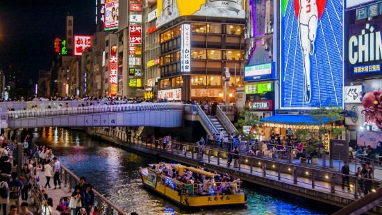 Image people walking on bridge near high rise buildings during nighttime