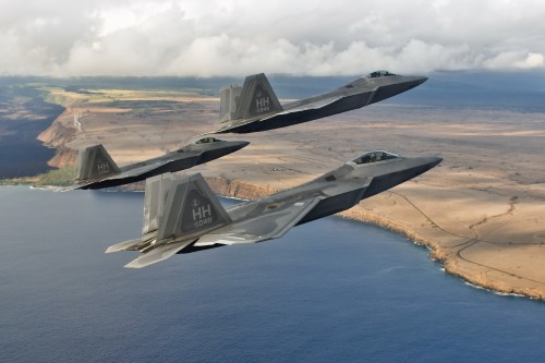 Image gray fighter plane flying over the sea during daytime