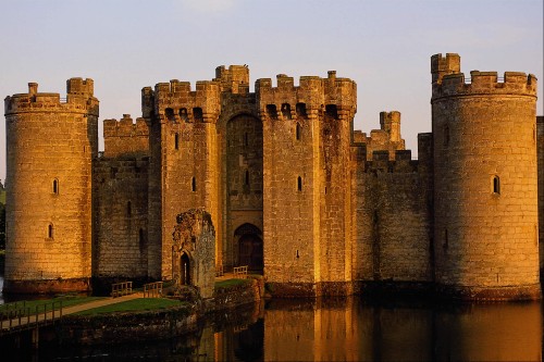 Image brown concrete castle near body of water during daytime