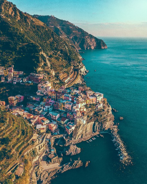 Image aerial view of city near body of water during daytime