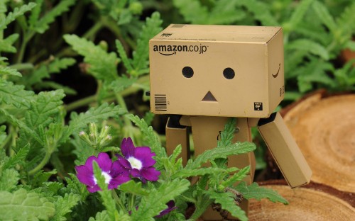 Image brown cardboard box robot on green plant