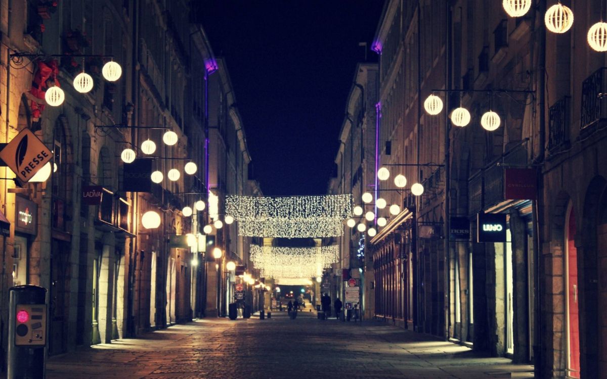 people walking on street during night time