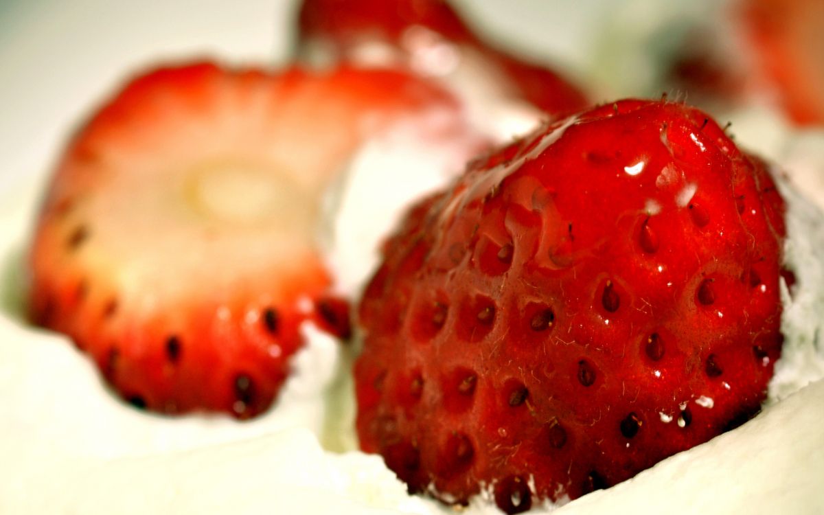 red strawberries on white cream