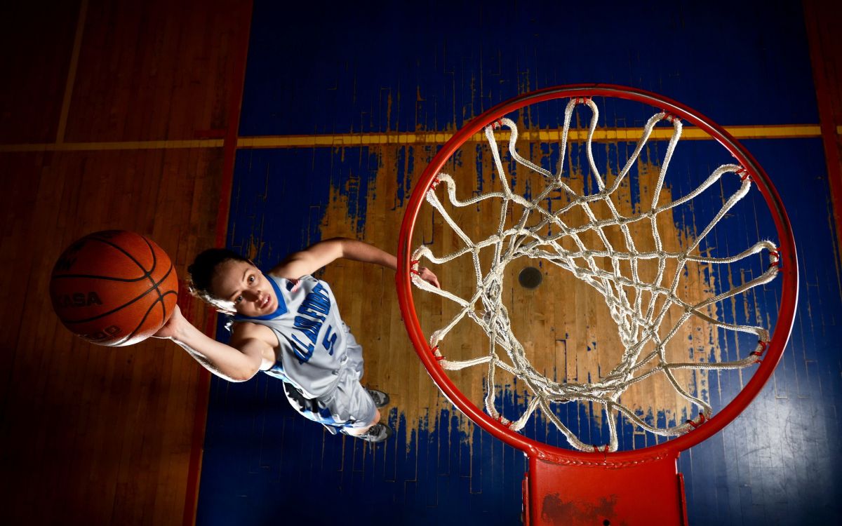 man in blue and white jersey shirt playing basketball