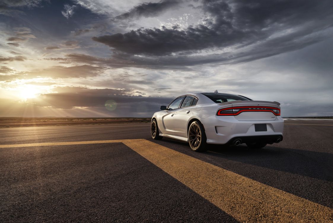 white porsche 911 on road under gray clouds