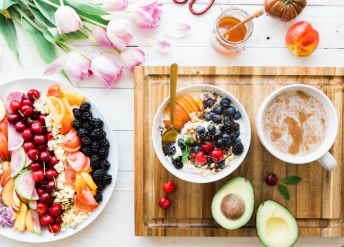 Image sliced fruits on white ceramic bowls