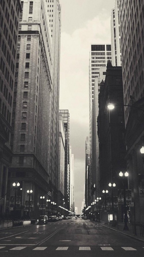 Image people walking on street between high rise buildings during daytime