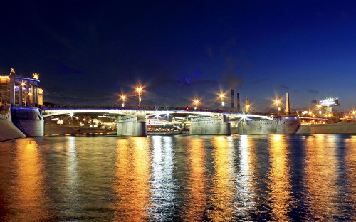 Image lighted bridge over river during night time