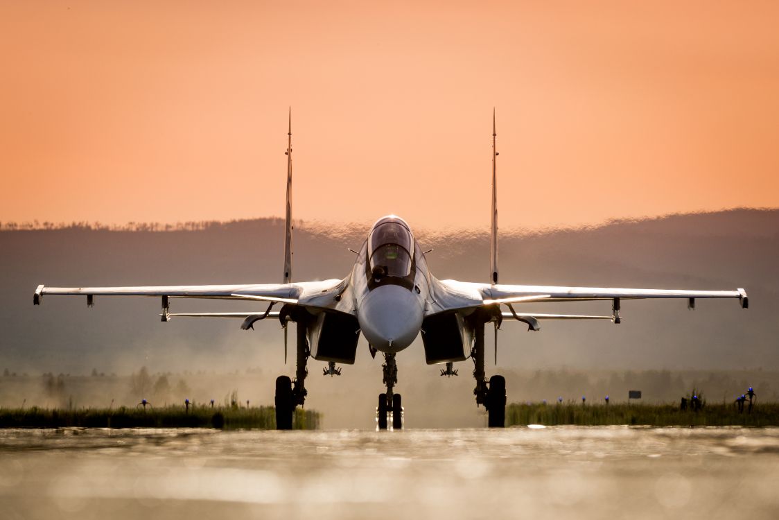 gray jet plane on gray field during daytime