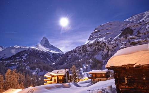 Image brown house on snow covered ground near snow covered mountain during daytime