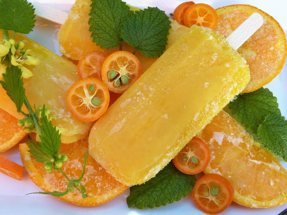 sliced orange fruit on white ceramic plate