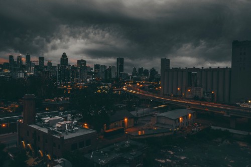 Image city with high rise buildings during night time