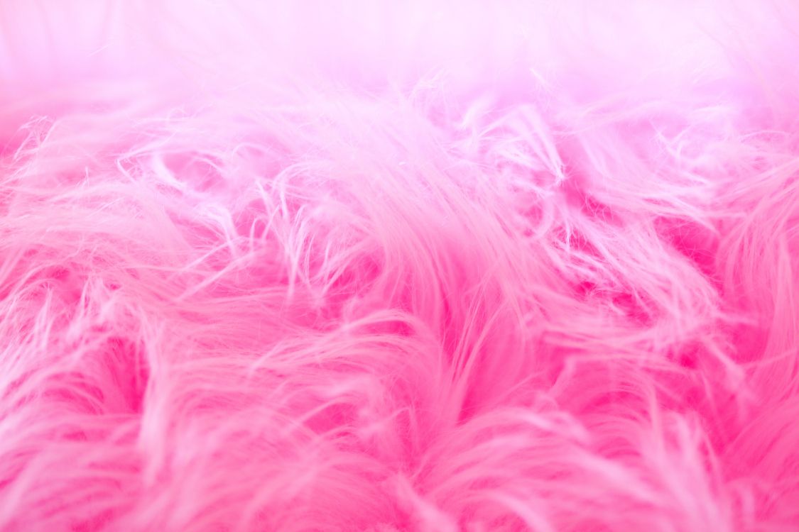 pink and white fur textile