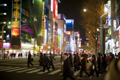 Image people walking on street during night time