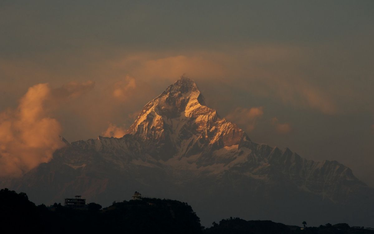 brown and white mountain under white sky during daytime