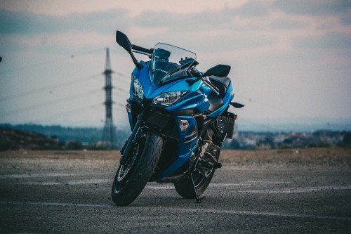 Image blue and black sports bike on gray asphalt road during daytime