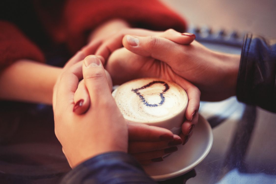 person holding white and brown round ornament