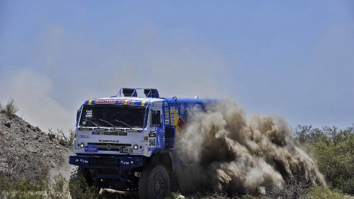 Image blue and white truck on green grass field under white clouds and blue sky during daytime