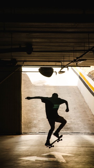 Image man in black shirt and black pants jumping on air