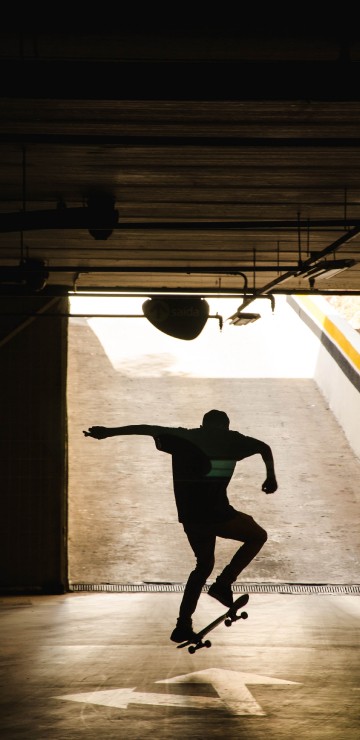 Image man in black shirt and black pants jumping on air