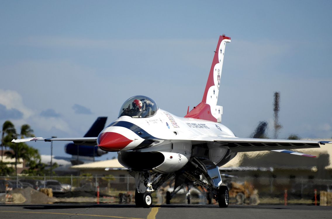 white and red jet plane in the sky