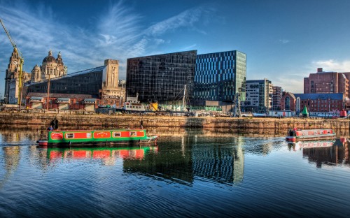 Image body of water near city buildings during daytime