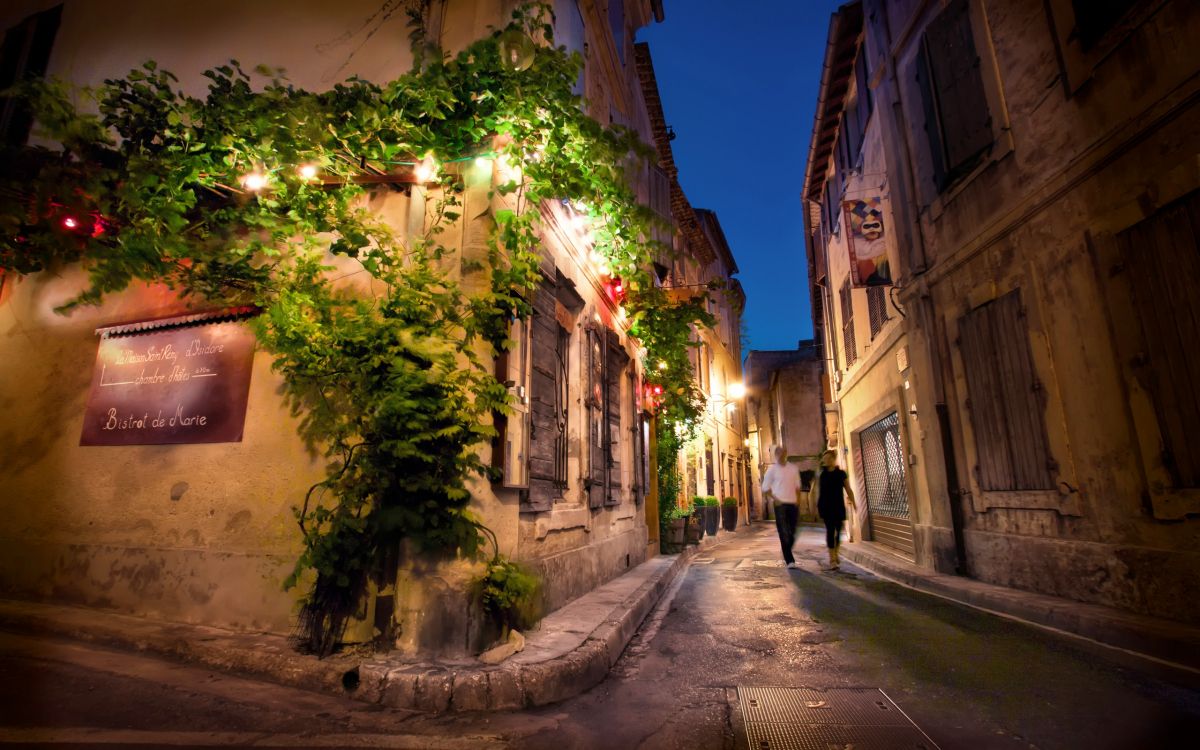 empty street in between buildings during night time