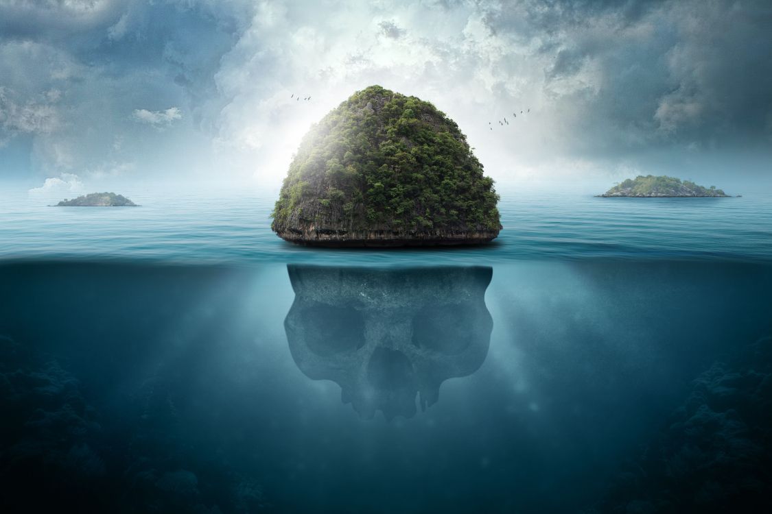 brown rock formation on body of water under white clouds and blue sky during daytime