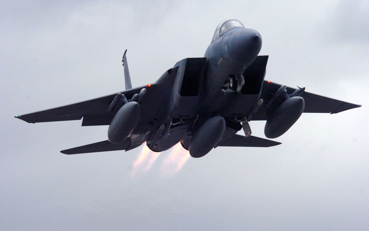 black jet plane in mid air during daytime