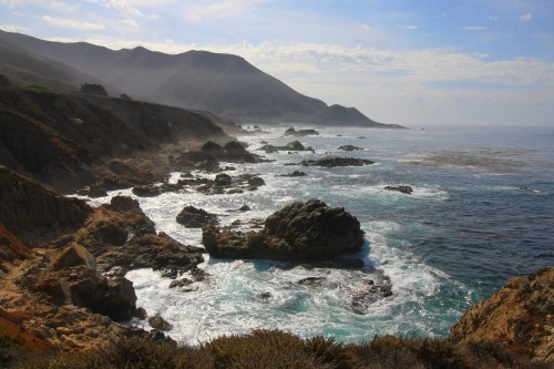 Image black rock formation on sea during daytime