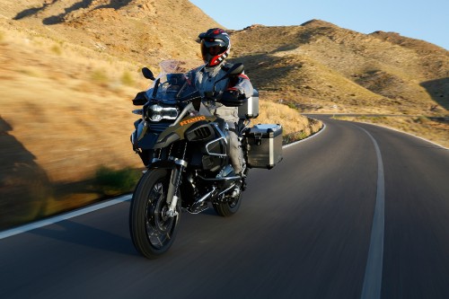 Image man in black helmet riding black motorcycle on road during daytime