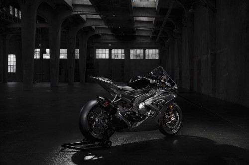 Image black and white sports bike parked on gray concrete floor