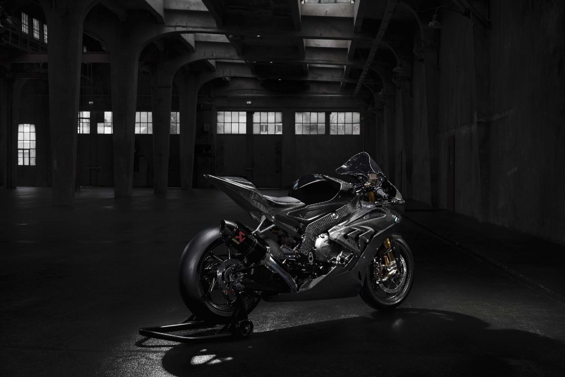 black and white sports bike parked on gray concrete floor