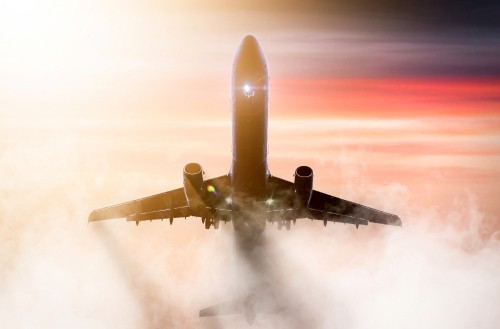 Image white airplane in mid air during daytime