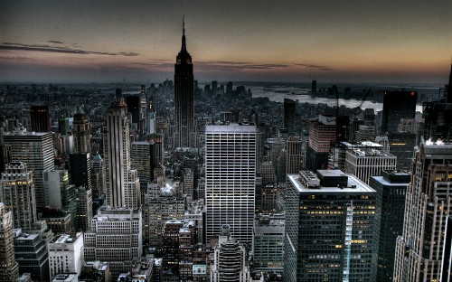 Image aerial view of city buildings during sunset