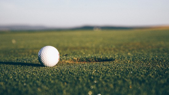 Image white golf ball on green grass field during daytime