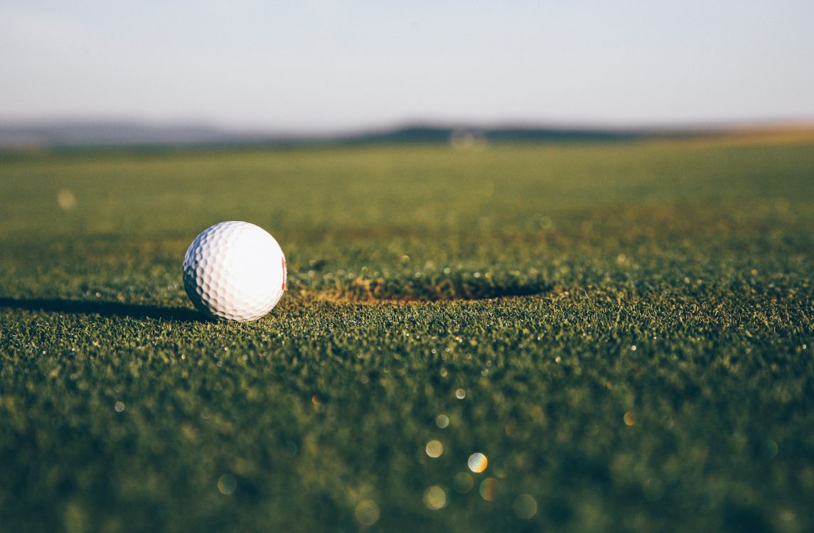 white golf ball on green grass field during daytime