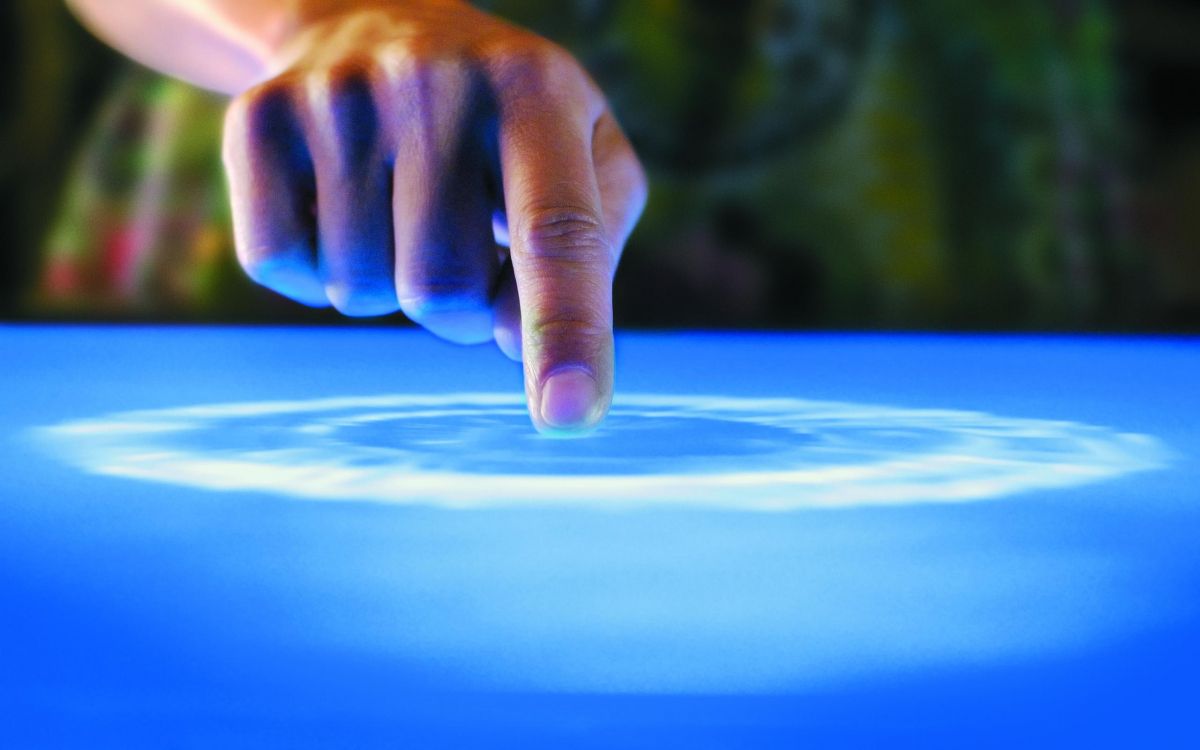 persons hand on blue textile